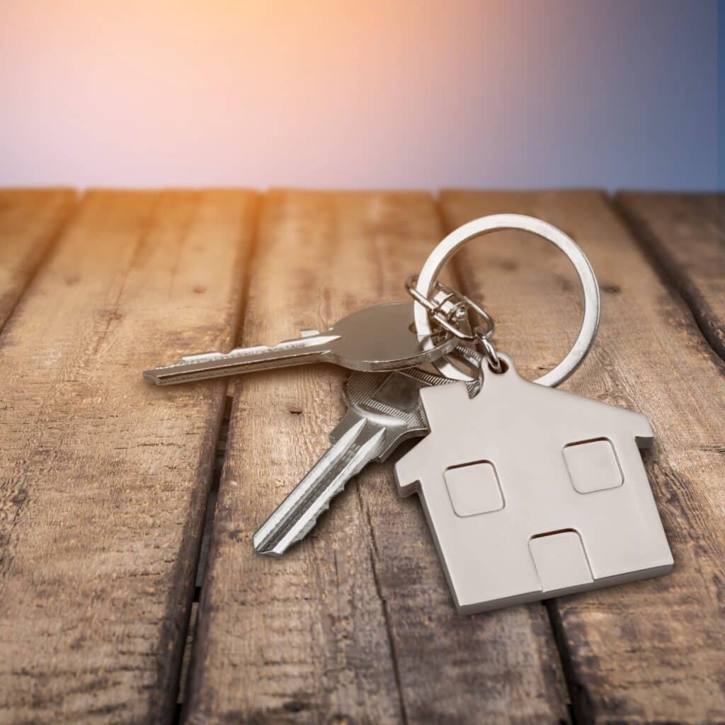 House keys with house figure on background