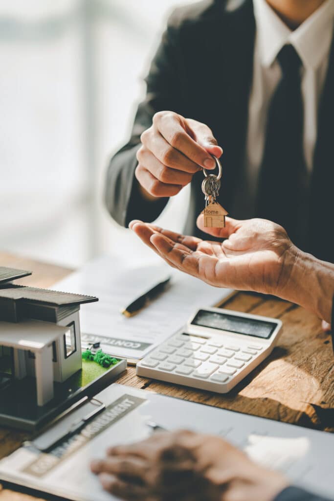 real estate agent Delivering keys and model homes to customers and home insurance contracts; home mortgage loan concepts