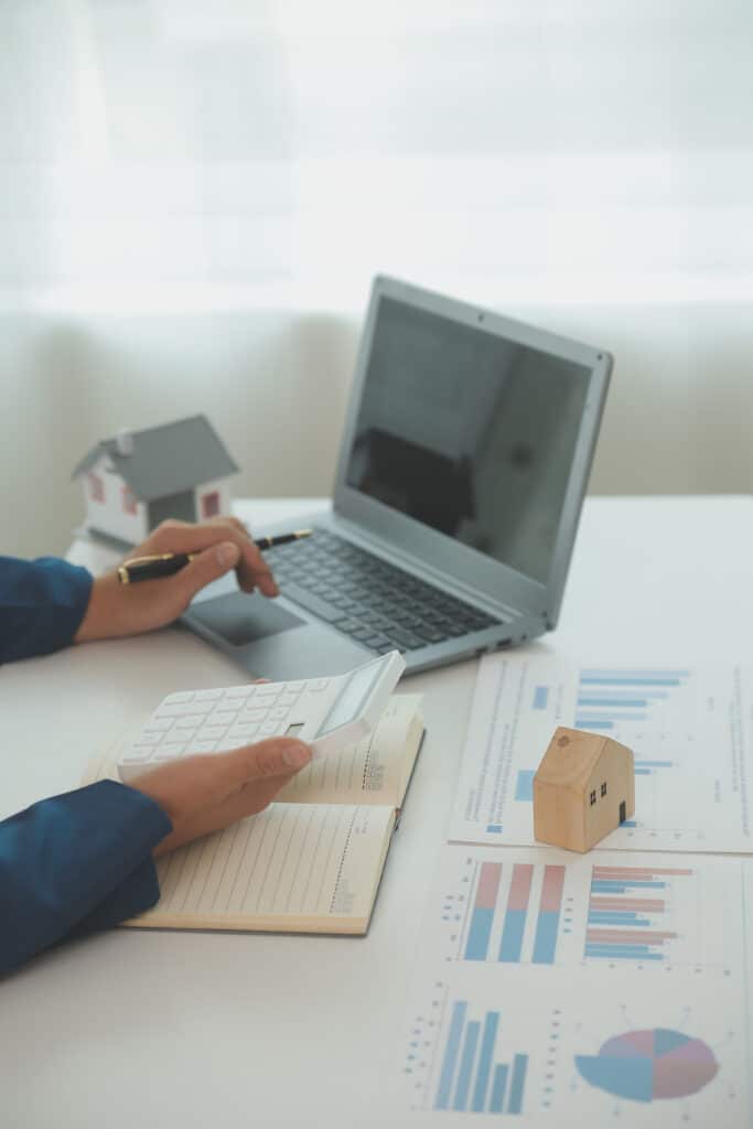 Businessmen holding pens, signing home titles with insurance, care about real estate services and the idea of real estate agents offering interest in installments to their customers.